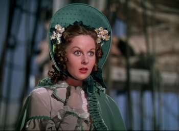 Movie still from “Reap the Wild Wind” (1942), directed by Cecil B. DeMille – A woman in a green dress and a green hat; Close Up shot, Low angle