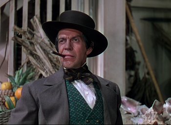 Movie still from “Reap the Wild Wind” (1942), directed by Cecil B. DeMille – A person wearing a suit and a hat; Medium shot, Low angle