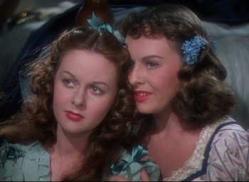 Movie still from “Reap the Wild Wind” (1942), directed by Cecil B. DeMille – Two beautiful young women posing for a picture; Close Up shot, High angle