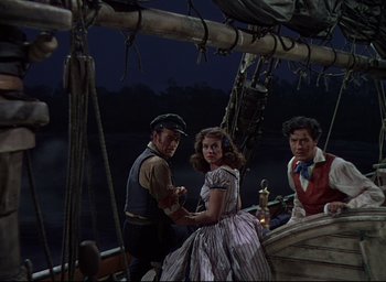 Movie still from “Reap the Wild Wind” (1942), directed by Cecil B. DeMille – A man and a woman on a boat with a man standing next to them; Medium shot, High angle