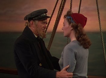 Movie still from “Reap the Wild Wind” (1942), directed by Cecil B. DeMille – An old man and a young woman on a boat in the ocean; Medium shot, Over the shoulder angle