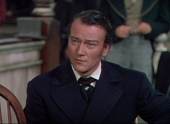 Movie still from “Reap the Wild Wind” (1942), directed by Cecil B. DeMille – A person wearing a suit and tie; Close Up shot, Over the shoulder angle