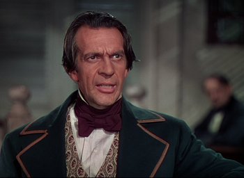 Movie still from “Reap the Wild Wind” (1942), directed by Cecil B. DeMille – A person wearing a suit and tie; Close Up shot, Low angle