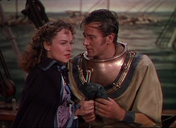 Movie still from “Reap the Wild Wind” (1942), directed by Cecil B. DeMille – A man and a woman standing next to each other; Medium shot, Over the shoulder angle