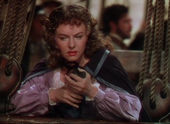 Movie still from “Reap the Wild Wind” (1942), directed by Cecil B. DeMille – A woman holding a bird in her hands; Close Up shot, High angle