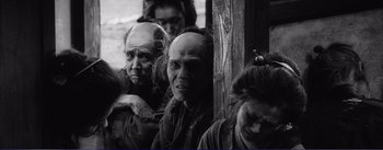 Movie still from “Red Beard” (1965), directed by Akira Kurosawa – A black and white photo of a group of people; Medium shot, Low angle