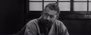 Movie still from “Red Beard” (1965), directed by Akira Kurosawa – Black and white photograph of a man with a beard; Close Up shot, Low angle