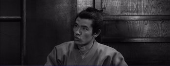 Movie still from “Red Beard” (1965), directed by Akira Kurosawa – A black and white photo of a man in a kimono; Close Up shot, High angle