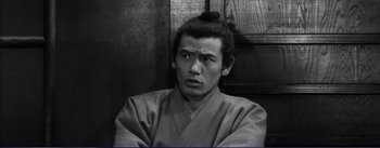 Movie still from “Red Beard” (1965), directed by Akira Kurosawa – A black and white photo of a man in a kimono; Close Up shot, High angle