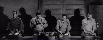 Movie still from “Red Beard” (1965), directed by Akira Kurosawa – Two men in traditional japanese garb preparing food in a kitchen; Medium shot, Low angle
