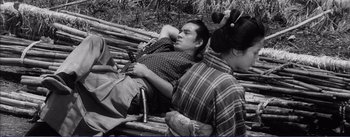 Movie still from “Red Beard” (1965), directed by Akira Kurosawa – A man and a woman are sitting on a bench; Medium shot, High angle