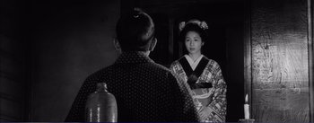 Movie still from “Red Beard” (1965), directed by Akira Kurosawa – A man and a woman in traditional japanese clothing; Medium shot, Over the shoulder angle