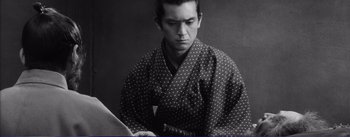 Movie still from “Red Beard” (1965), directed by Akira Kurosawa – A young man in a black and white kimono; Medium shot, Low angle