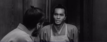 Movie still from “Red Beard” (1965), directed by Akira Kurosawa – A black and white photo of a man and a woman; Close Up shot, Over the shoulder angle