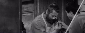 Movie still from “Red Beard” (1965), directed by Akira Kurosawa – Black and white photograph of a man with a beard; Close Up shot, High angle