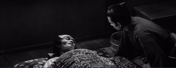 Movie still from “Red Beard” (1965), directed by Akira Kurosawa – A man and a woman are talking to each other; Medium shot, Over the shoulder angle