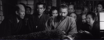 Movie still from “Red Beard” (1965), directed by Akira Kurosawa – A group of people sitting in front of a curtain; Medium shot, High angle