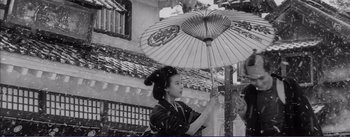 Movie still from “Red Beard” (1965), directed by Akira Kurosawa – A woman holding an open umbrella in an old photo; Medium shot, Low angle