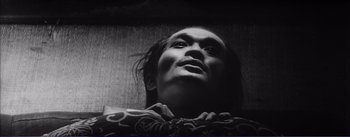 Movie still from “Red Beard” (1965), directed by Akira Kurosawa – A black - and - white photo of a man's face; Close Up shot, Low angle