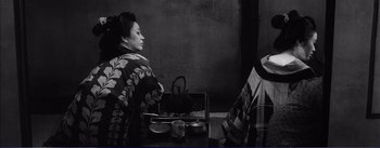 Movie still from “Red Beard” (1965), directed by Akira Kurosawa – A woman sitting at a table in front of a tea pot; Medium shot, High angle