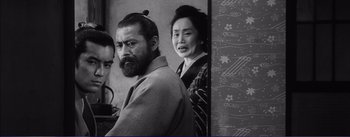 Movie still from “Red Beard” (1965), directed by Akira Kurosawa – A man and a woman standing next to each other; Medium shot, Over the shoulder angle