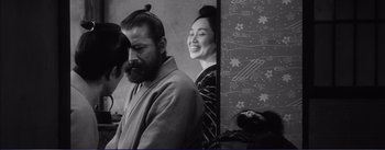 Movie still from “Red Beard” (1965), directed by Akira Kurosawa – A man and a woman standing next to each other; Medium shot, Over the shoulder angle