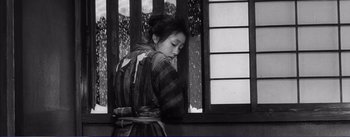 Movie still from “Red Beard” (1965), directed by Akira Kurosawa – A young woman in a kimono is leaning against a window; Medium shot, Low angle
