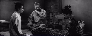Movie still from “Red Beard” (1965), directed by Akira Kurosawa – A man sitting on the floor brushing his teeth; Medium shot, Over the shoulder angle