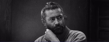 Movie still from “Red Beard” (1965), directed by Akira Kurosawa – Black and white photograph of a man with a beard; Close Up shot, Low angle