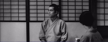 Movie still from “Red Beard” (1965), directed by Akira Kurosawa – A black and white photo of a man in a kimono; Close Up shot, Low angle