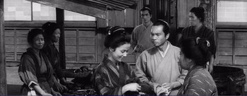 Movie still from “Red Beard” (1965), directed by Akira Kurosawa – A woman and two men in traditional japanese garb in a kitchen; Medium shot, Low angle
