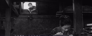 Movie still from “Red Beard” (1965), directed by Akira Kurosawa – A black and white photo of a boy and a woman; Medium shot, Low angle