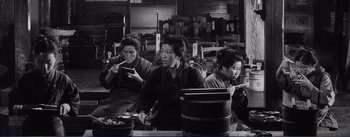 Movie still from “Red Beard” (1965), directed by Akira Kurosawa – A group of women sitting around a table; Medium shot, High angle