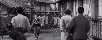 Movie still from “Red Beard” (1965), directed by Akira Kurosawa – An old photo of a woman and a man in traditional japanese clothing; Wide shot, Low angle