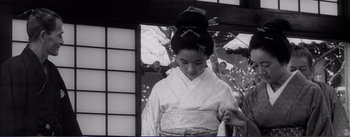 Movie still from “Red Beard” (1965), directed by Akira Kurosawa – A young woman in a geisha outfit looking down; Medium shot, Low angle