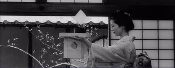 Movie still from “Red Beard” (1965), directed by Akira Kurosawa – A woman in a kimono holding an apple in her hand; Medium shot, Low angle