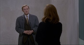 Movie still from “Red Desert” (1964), directed by Michelangelo Antonioni – A man and a woman are standing in front of a mirror; Medium shot, Over the shoulder angle