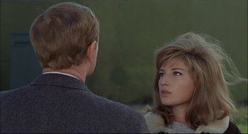 Movie still from “Red Desert” (1964), directed by Michelangelo Antonioni – A man and a woman talking to each other; Close Up shot, Over the shoulder angle