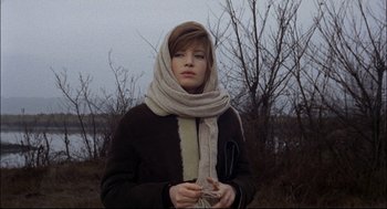 Movie still from “Red Desert” (1964), directed by Michelangelo Antonioni – A young woman wearing a scarf and a jacket; Medium shot, Low angle