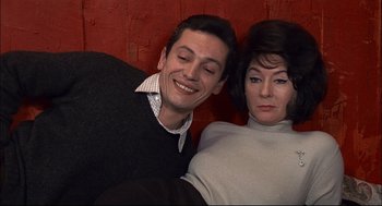 Movie still from “Red Desert” (1964), directed by Michelangelo Antonioni – A man and a woman smiling for the camera; Close Up shot, High angle