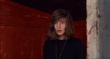 Movie still from “Red Desert” (1964), directed by Michelangelo Antonioni – A young woman with brown hair wearing a black shirt; Close Up shot, Low angle