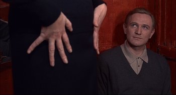Movie still from “Red Desert” (1964), directed by Michelangelo Antonioni – A man and a woman standing next to each other; Close Up shot, Over the shoulder angle