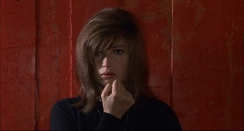 Movie still from “Red Desert” (1964), directed by Michelangelo Antonioni – A young woman with brown hair wearing a black shirt; Close Up shot, Low angle