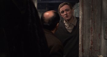 Movie still from “Red Desert” (1964), directed by Michelangelo Antonioni – A man looking at himself in the mirror; Close Up shot, Over the shoulder angle