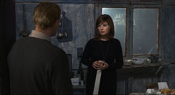 Movie still from “Red Desert” (1964), directed by Michelangelo Antonioni – A man and a woman standing in front of a mirror; Medium shot, Over the shoulder angle