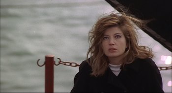 Movie still from “Red Desert” (1964), directed by Michelangelo Antonioni – A beautiful woman with long brown hair standing next to a metal fence; Close Up shot, Low angle