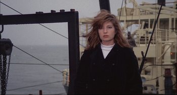 Movie still from “Red Desert” (1964), directed by Michelangelo Antonioni – A woman standing on top of a boat in the water; Medium shot, Low angle