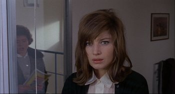 Movie still from “Red Desert” (1964), directed by Michelangelo Antonioni – A person wearing a jacket; Close Up shot, Over the shoulder angle