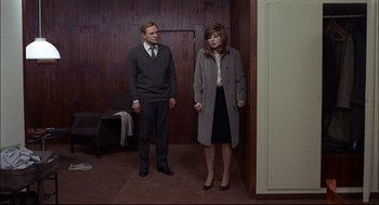 Movie still from “Red Desert” (1964), directed by Michelangelo Antonioni – A man and a woman standing next to each other in a room; Wide shot, High angle