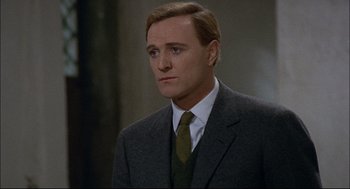 Movie still from “Red Desert” (1964), directed by Michelangelo Antonioni – A person wearing a suit and tie; Close Up shot, Over the shoulder angle